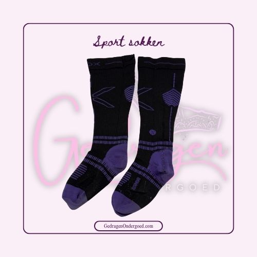 Lange zwarte compressie sport sokken gepresenteerd op de grond met paars